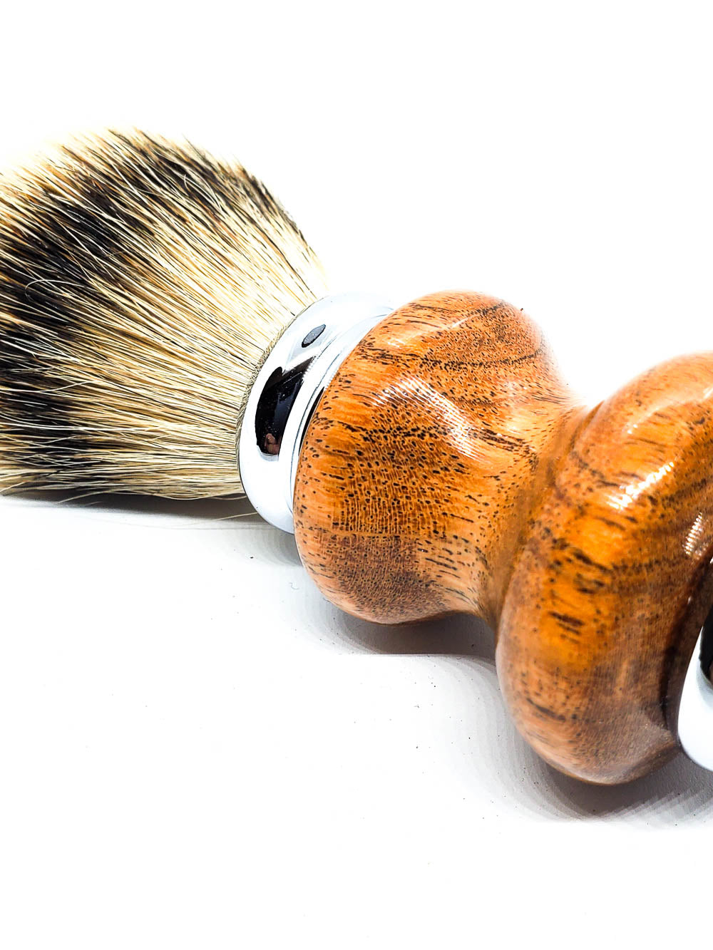 close up of a mesquite handle on a shave brush with a black badger knot