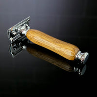 natural hardwood razor handle mango wood grain on a dark reflective surface