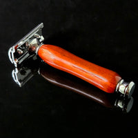 Shaving razor with a wooden handle on a black background