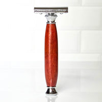 Safety razor with a modern handle made from padauk on a white background