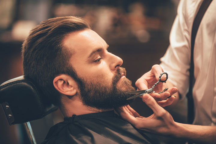 man getting beard trimmed