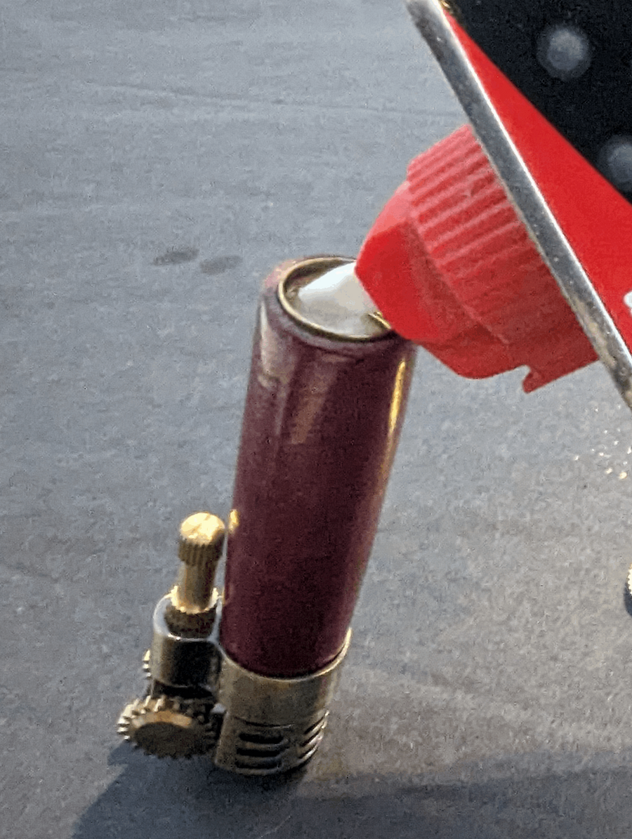 filling a lighter with lighter fluid