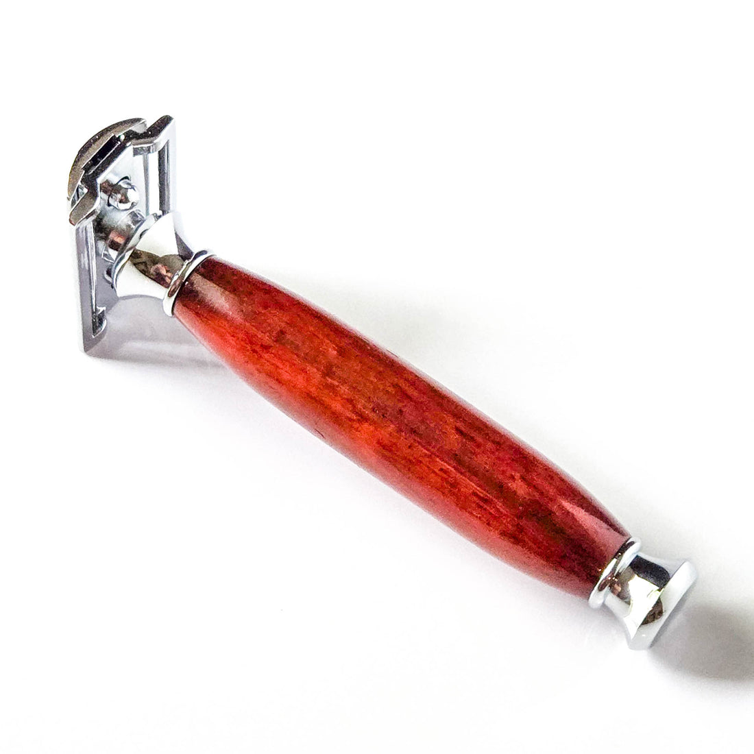 Shaving razor with a red wooden handle on a white background