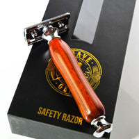 Safety razor with a wooden handle on a black gift box labeled 'Safety Razor'.