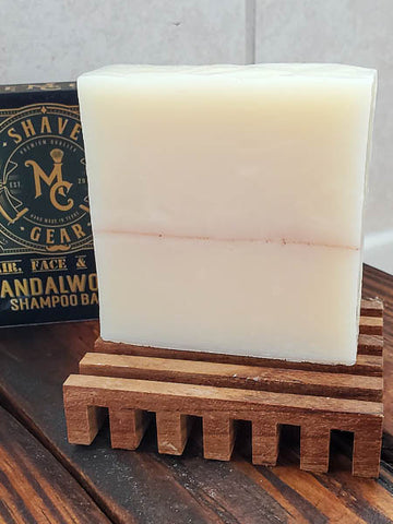 Sandalwood shampoo bar for men on a teak soap tray