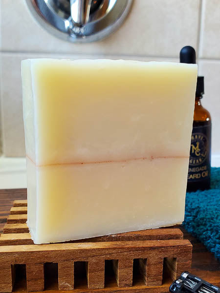 Sandalwood shampoo bar for men with a bottle of beard oil.