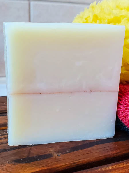 Sandalwood shampoo bar for men on the bath tray. The best bar soap for hair, face and body.