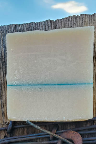 bay rum scent shampoo bar for men on a fence 